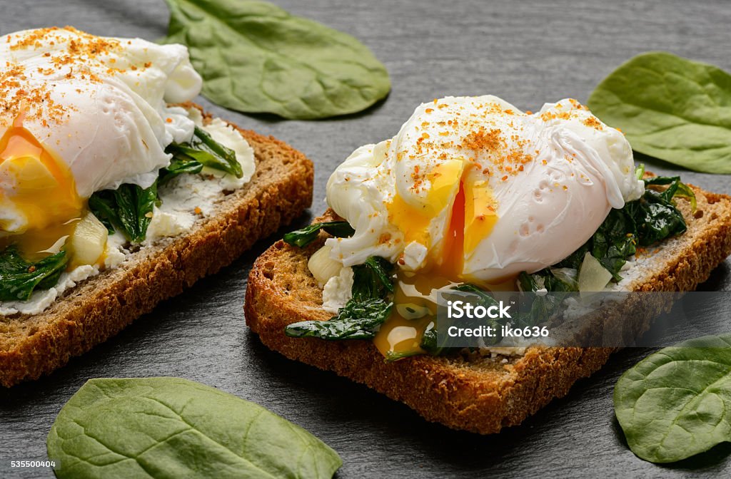 Healthy breakfast - sandwich with cheese, spinach and poached egg.